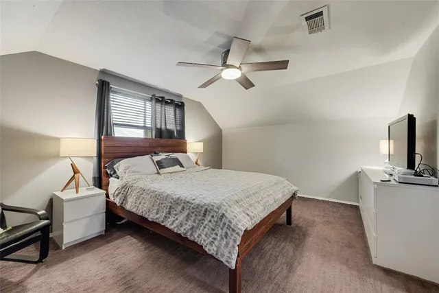 a bedroom with a bed and flat screen tv