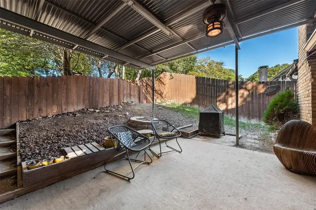 a view of a chairs and table in backyard