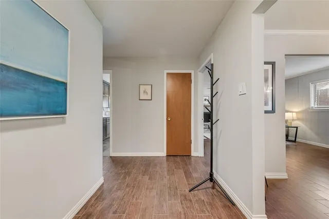 a view of hallway with wooden floor