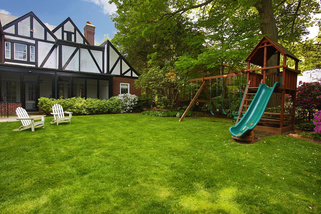135 Willard Road Brookline, MA 02445 - Photo 13 of 14 a view of a house with a backyard and a tree