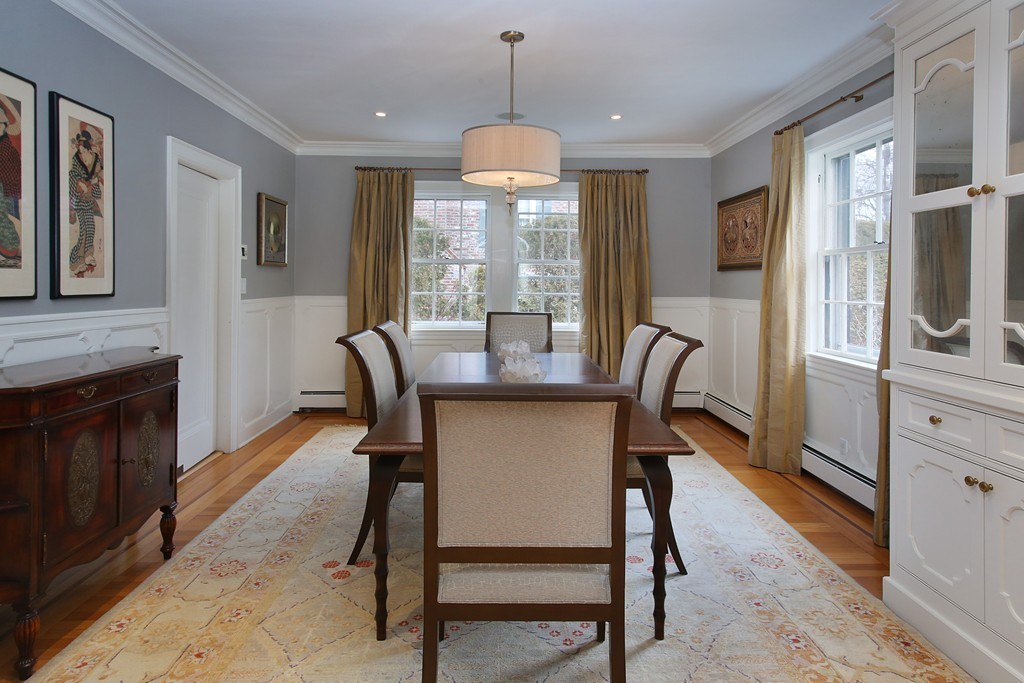135 Willard Road Brookline, MA 02445 - Photo 3 of 14 a dining room with furniture a chandelier and wooden floor