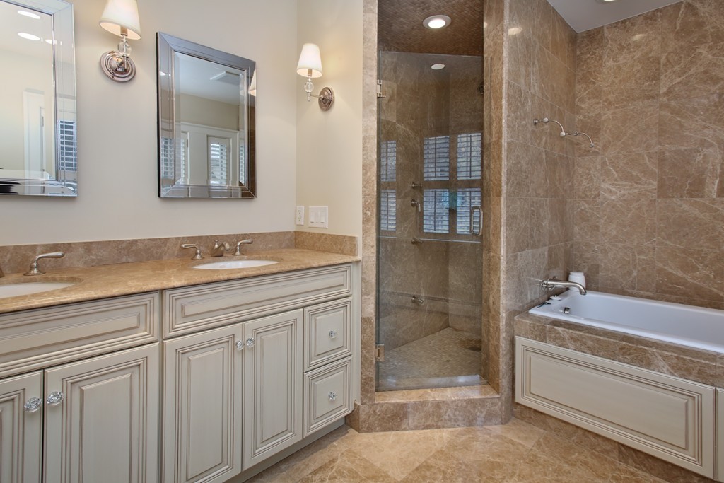 135 Willard Road Brookline, MA 02445 - Photo 8 of 14 a spacious bathroom with a granite countertop sink a toilet mirror and shower