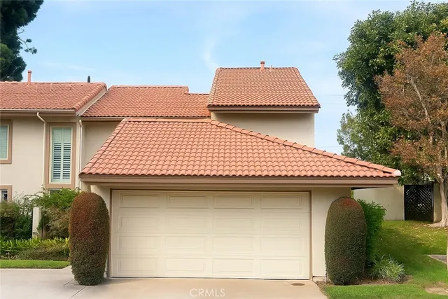 a front view of a house with garage