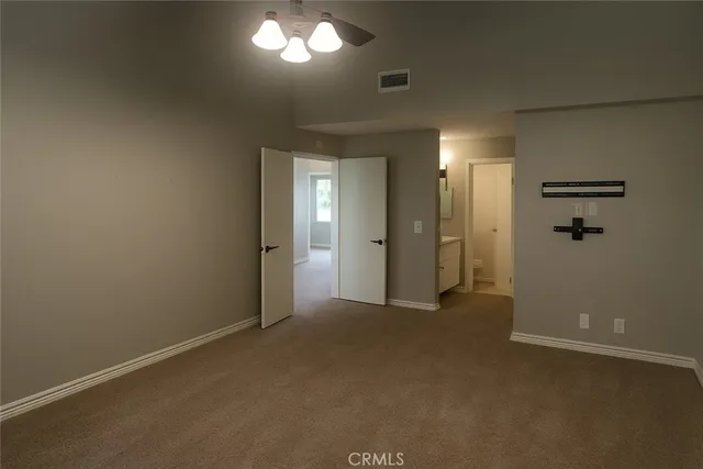 an empty room with closet and a bathroom