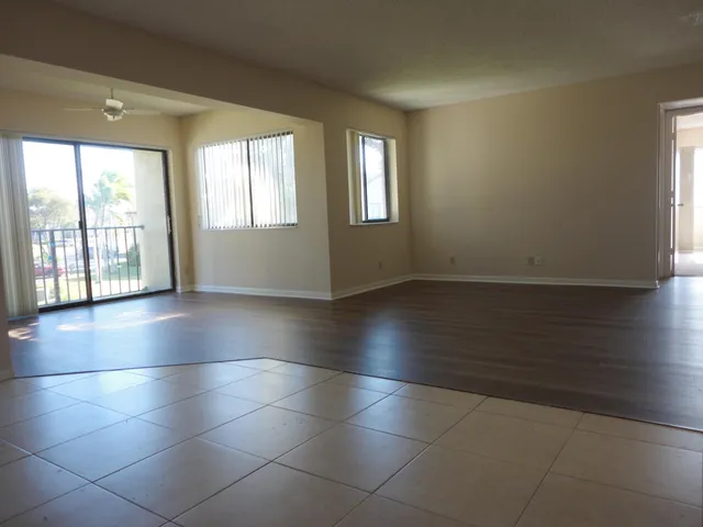 a view of an empty room with glass door