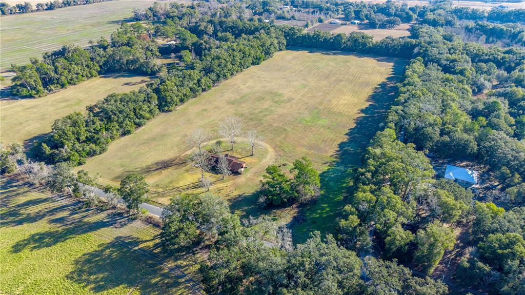 0 Southwest 202nd Street Newberry, FL 32669 - Photo 5 of 12 an aerial view of a house with a yard and lake view