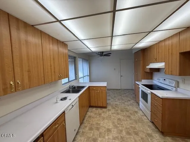 a kitchen that has a sink and a stove