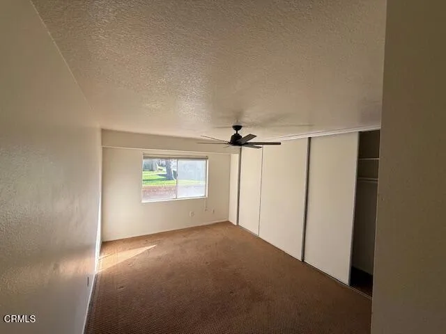 an empty room with windows and closet