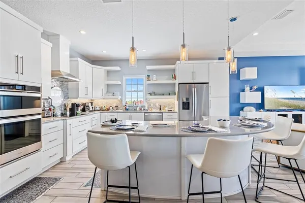a kitchen with stainless steel appliances kitchen island granite countertop a sink and cabinets