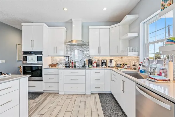 a kitchen with stainless steel appliances cabinets and a sink