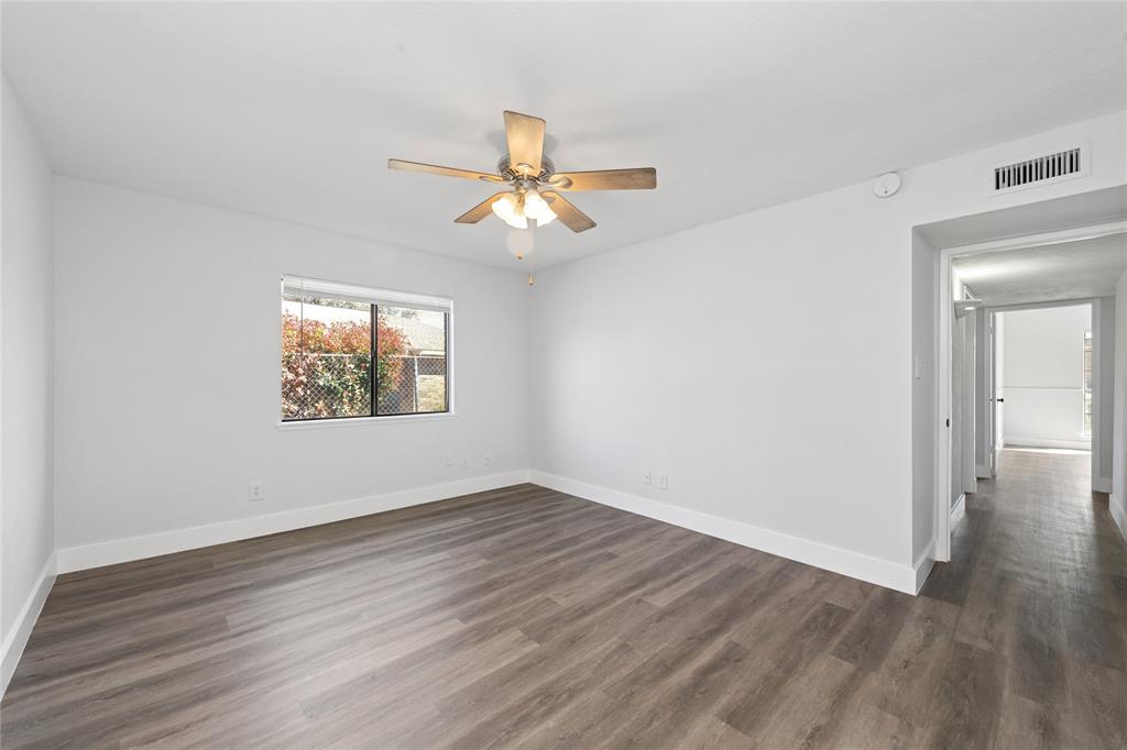 2119 Meadfoot Road Carrollton, TX 75007 - Photo 24 of 30 Spare room with ceiling fan and dark wood-style flooring