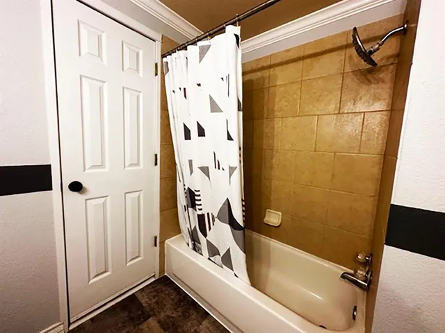 a bathroom with a tub and shower