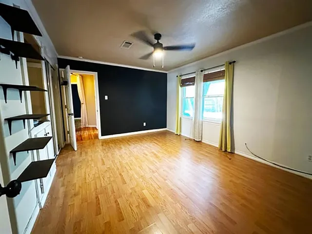 wooden floor in an empty room with a window