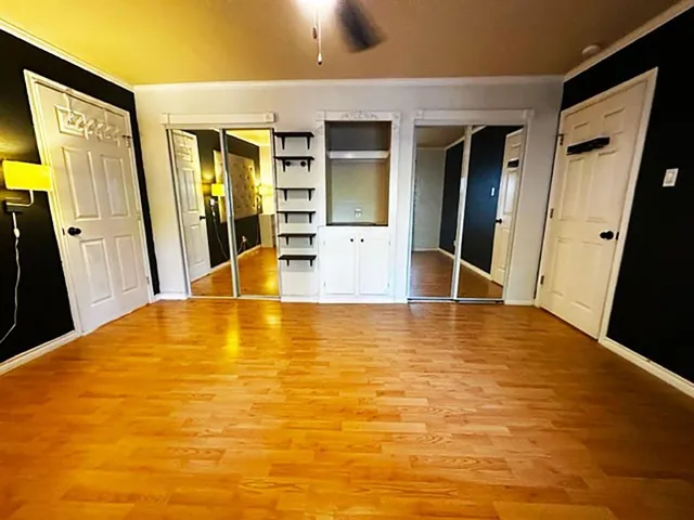 a view of a living room with furniture and a large window