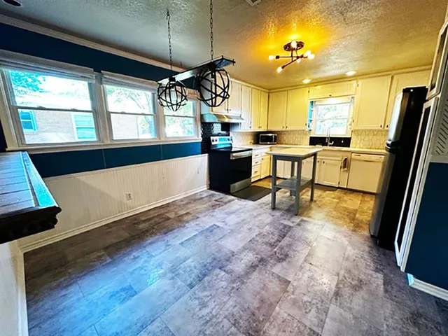 a view of kitchen with furniture and a window