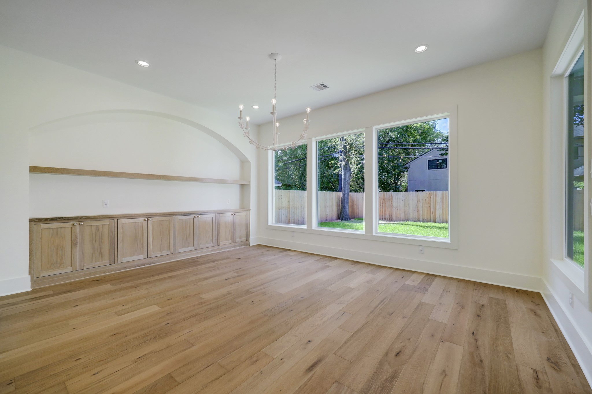 955 West 42nd Street Houston, TX 77018 - Photo 11 of 49 a view of an empty room with wooden floor and a window
