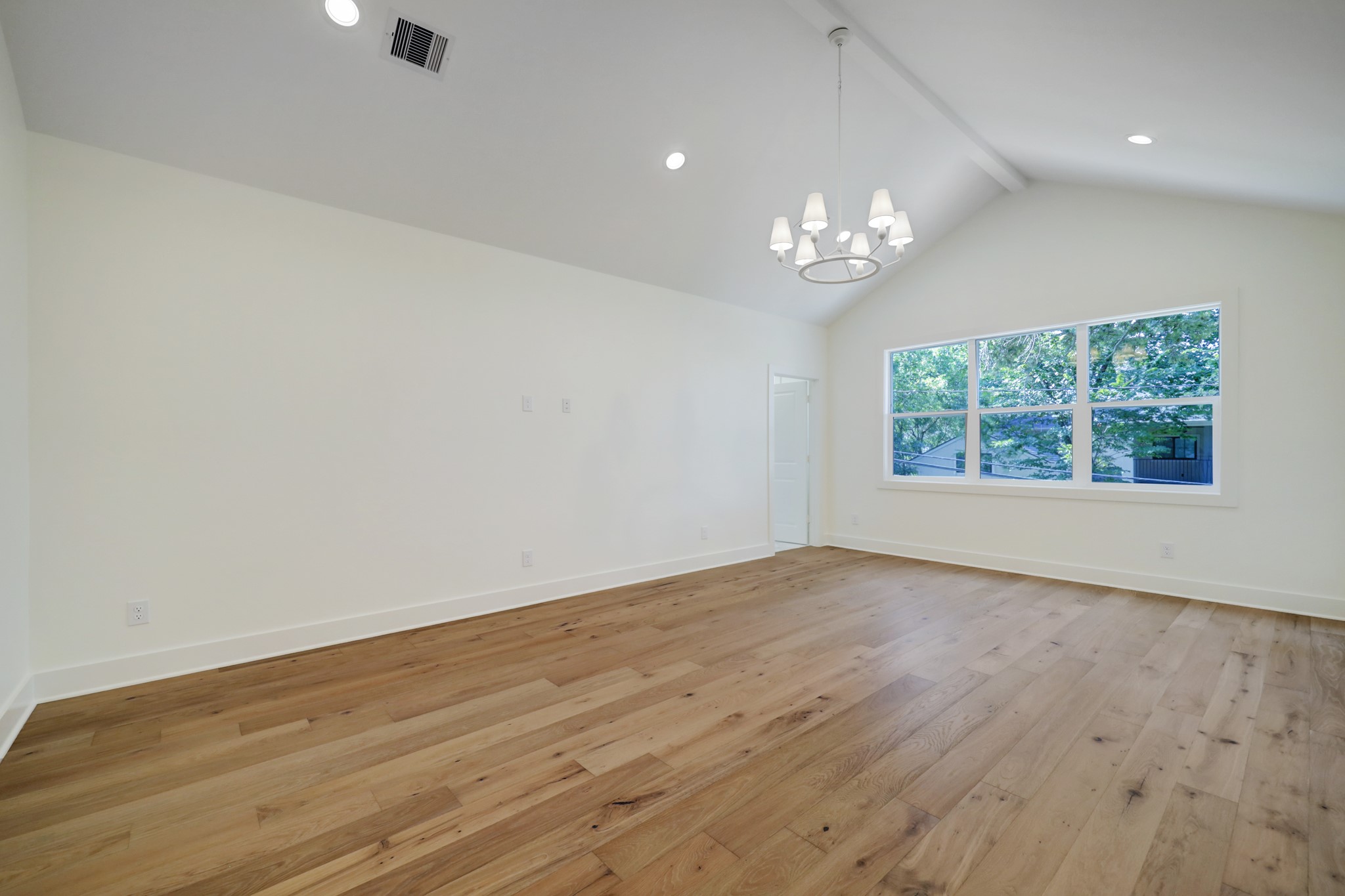 955 West 42nd Street Houston, TX 77018 - Photo 13 of 49 an empty room with wooden floor chandelier fan and windows