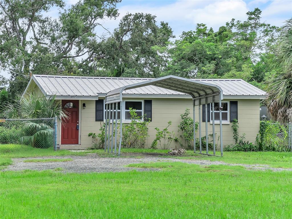 a view of a house with a yard and plants