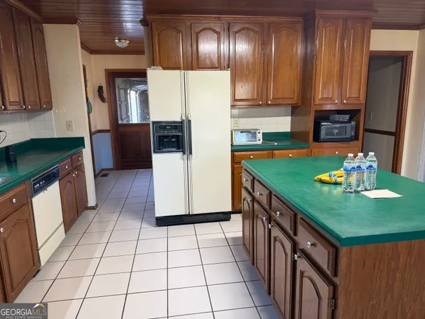a kitchen with stainless steel appliances granite countertop a refrigerator a stove a sink and dishwasher