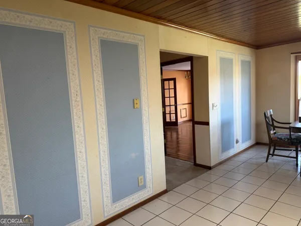 a view of kitchen with furniture and refrigerator