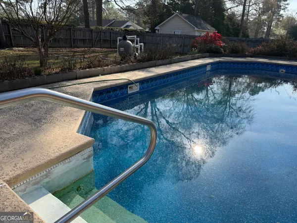 a view of a backyard with swimming pool
