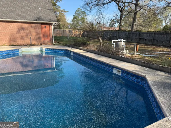 a view of a pool with a yard