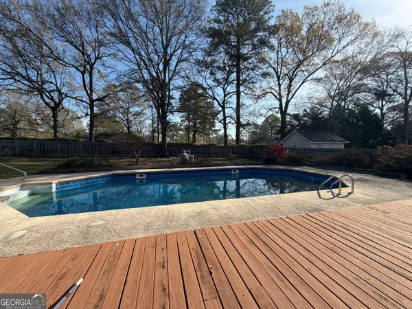 a view of outdoor space with swimming pool and sitting space