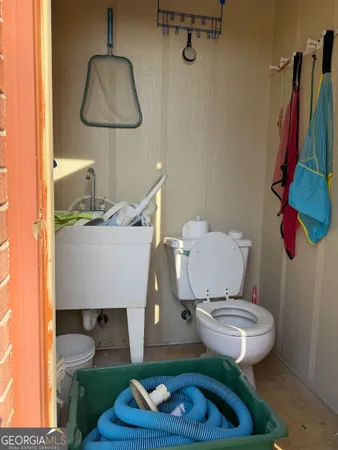 a bathroom with a sink toilet and a mirror