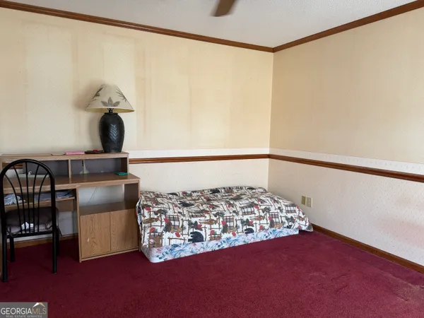 a bedroom with a bed and a window on the wall