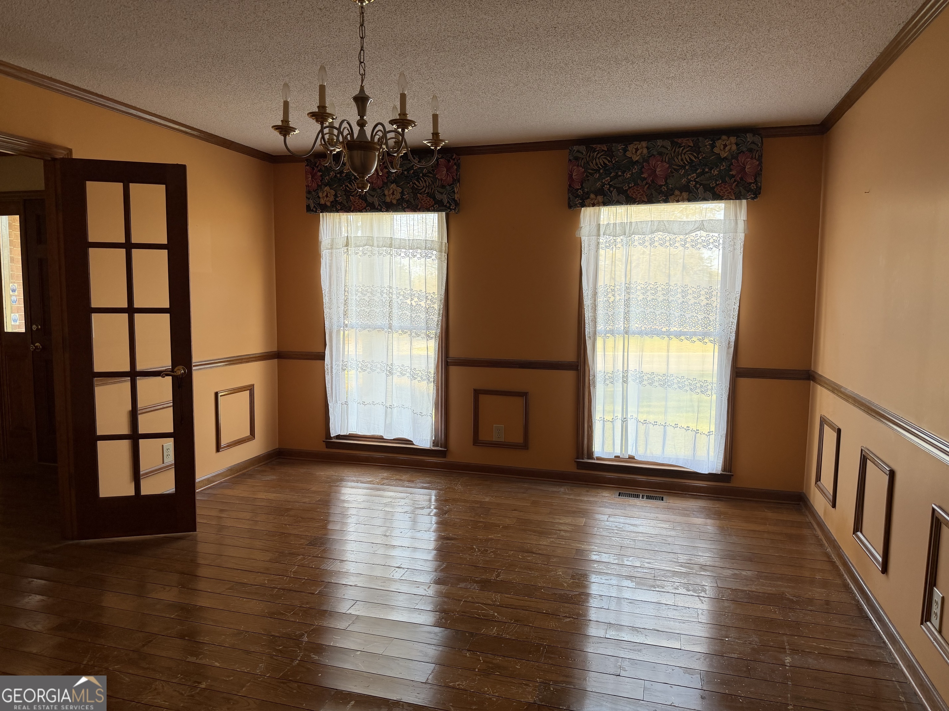 206 Ridge Circle Dublin, GA 31021 - Photo 8 of 40 a view of an empty room with wooden floor and a window