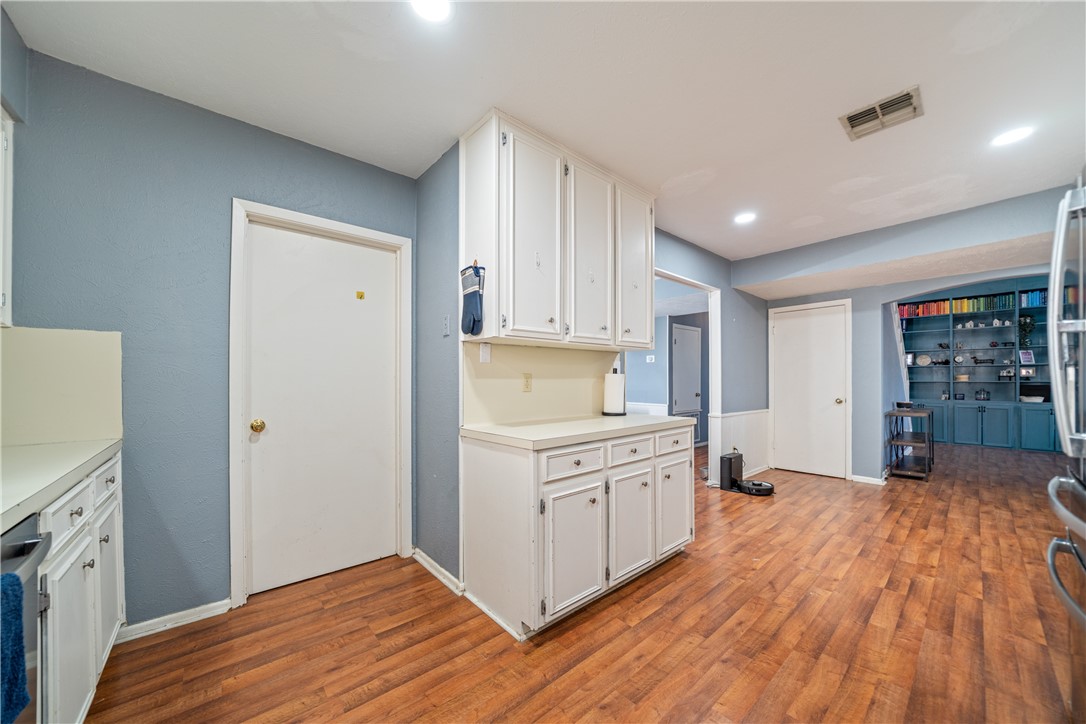 2217 Post Oak Drive Portland, TX 78374 - Photo 13 of 39 a kitchen with stainless steel appliances white cabinets and wooden floors