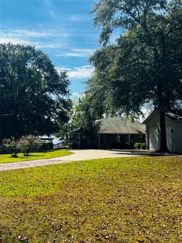 a spacious bedroom with a bed and a chandelier