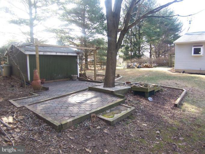 1221 Marclee Road Finksburg, MD 21048 - Photo 13 of 15 a view of a backyard with large trees and wooden fence