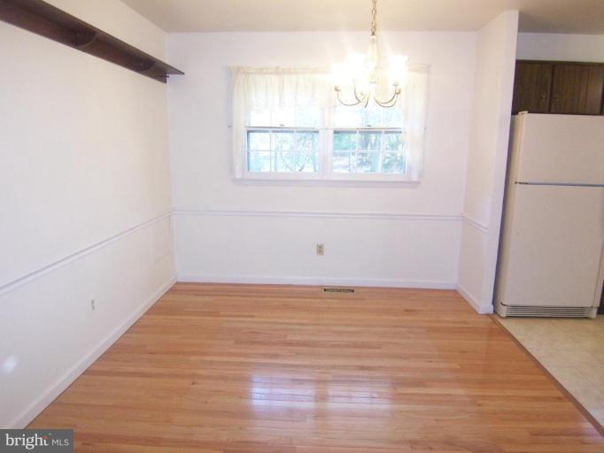 1221 Marclee Road Finksburg, MD 21048 - Photo 5 of 15 a view of an empty room with wooden floor and a window