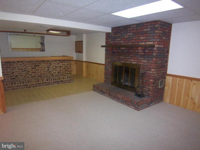 1221 Marclee Road Finksburg, MD 21048 - Photo 7 of 15 a view of empty room with fireplace and wooden floor