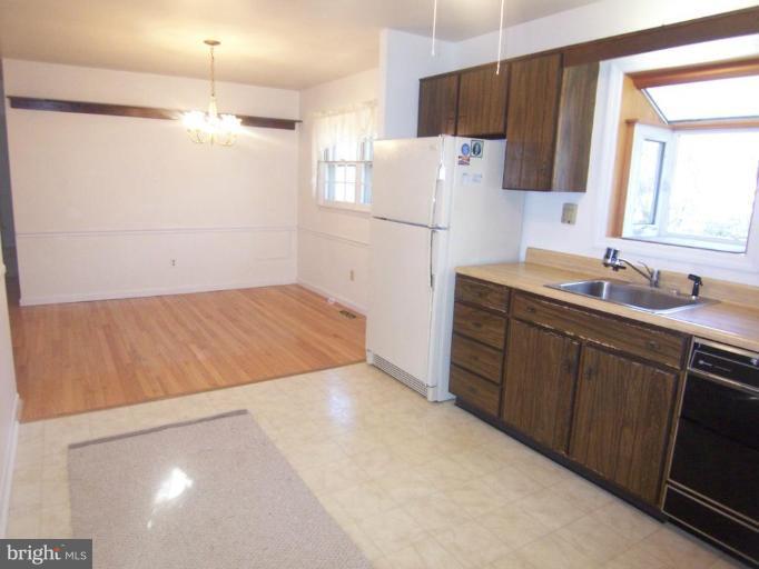 1221 Marclee Road Finksburg, MD 21048 - Photo 8 of 15 a kitchen with refrigerator and cabinets