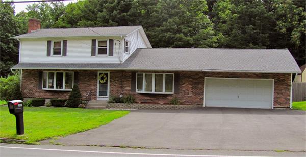 202 Easthampton Road Holyoke, MA 01040 - Photo 1 of 12 a front view of a house with a yard and a garage