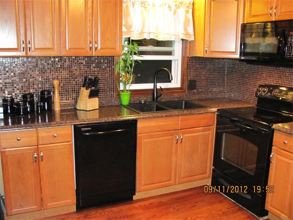 202 Easthampton Road Holyoke, MA 01040 - Photo 3 of 12 a kitchen with granite countertop a sink stove and cabinets