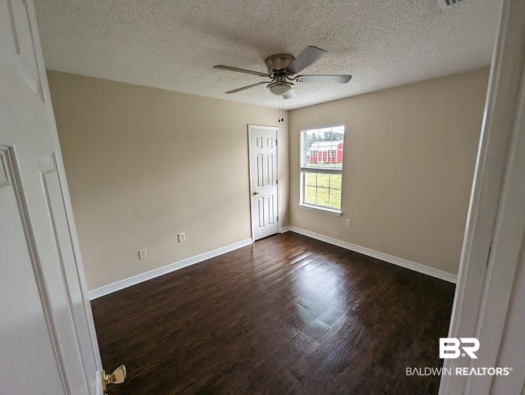 12971 Labradors Run Foley, AL 36535 - Photo 14 of 23 Spacious interior room featuring wood-finish flooring, neutral wall paint, and a textured ceiling