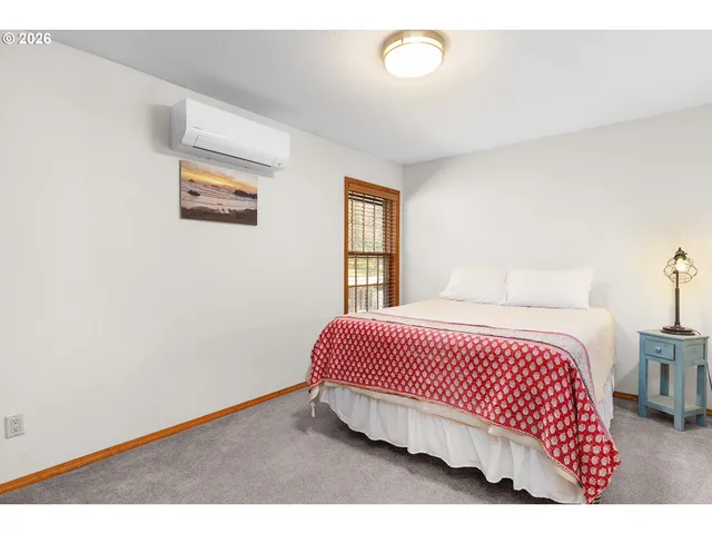 a bedroom with a bed and a table