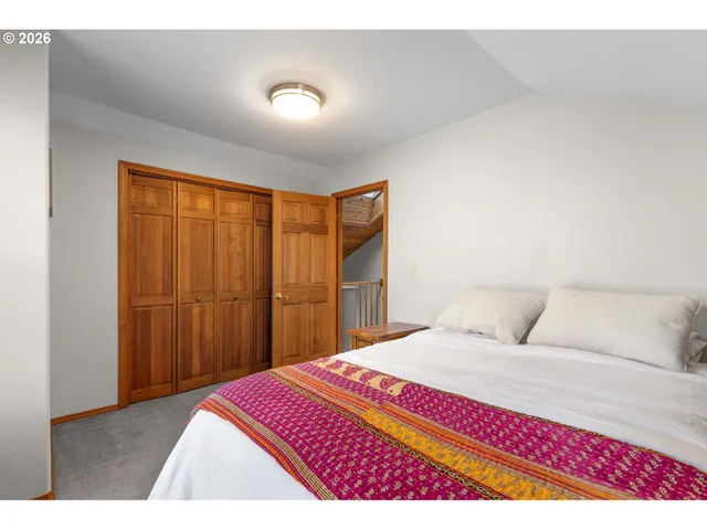 a bedroom with a large bed and a couch