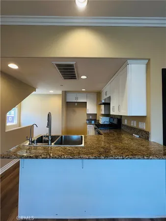 a bathroom with a granite countertop sink and a granite counter top