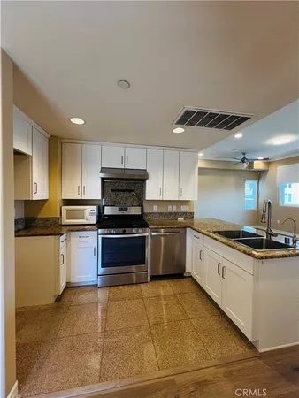 a kitchen with stainless steel appliances and cabinets