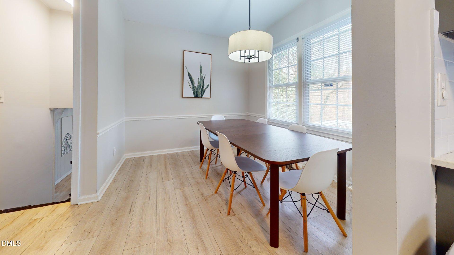 7720 Foxwood Drive Raleigh, NC 27615 - Photo 11 of 46 a view of a dining room with furniture window and wooden floor