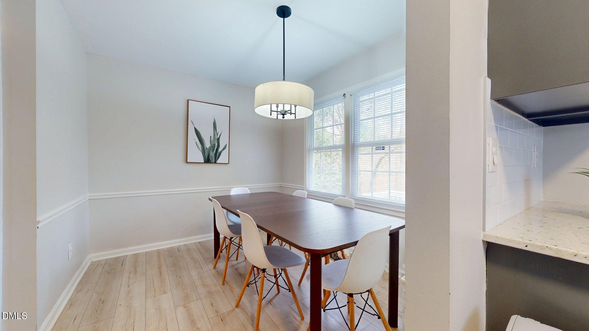 7720 Foxwood Drive Raleigh, NC 27615 - Photo 12 of 46 a room with chandelier and wooden floor