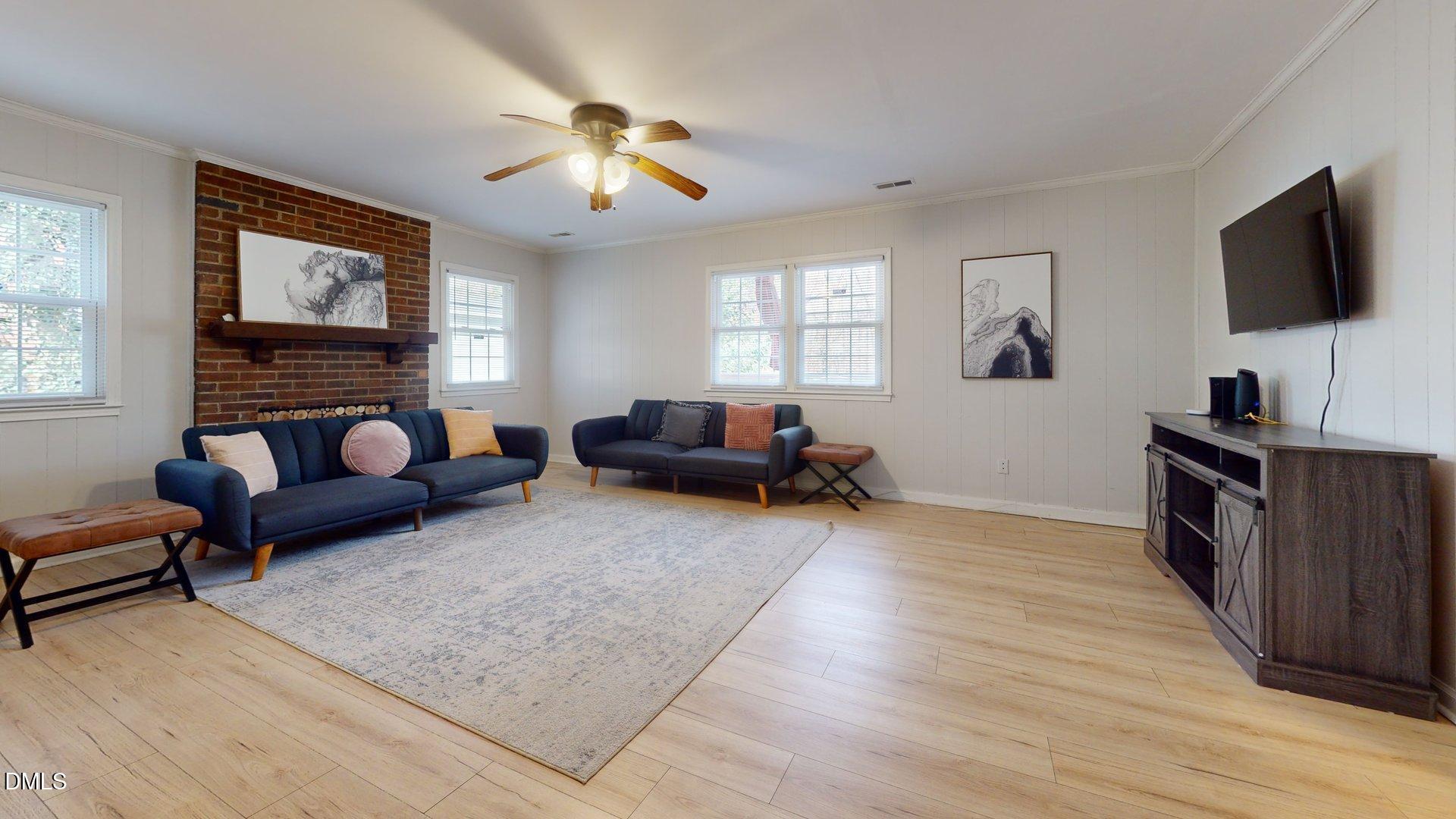 7720 Foxwood Drive Raleigh, NC 27615 - Photo 18 of 46 a living room with furniture and a flat screen tv