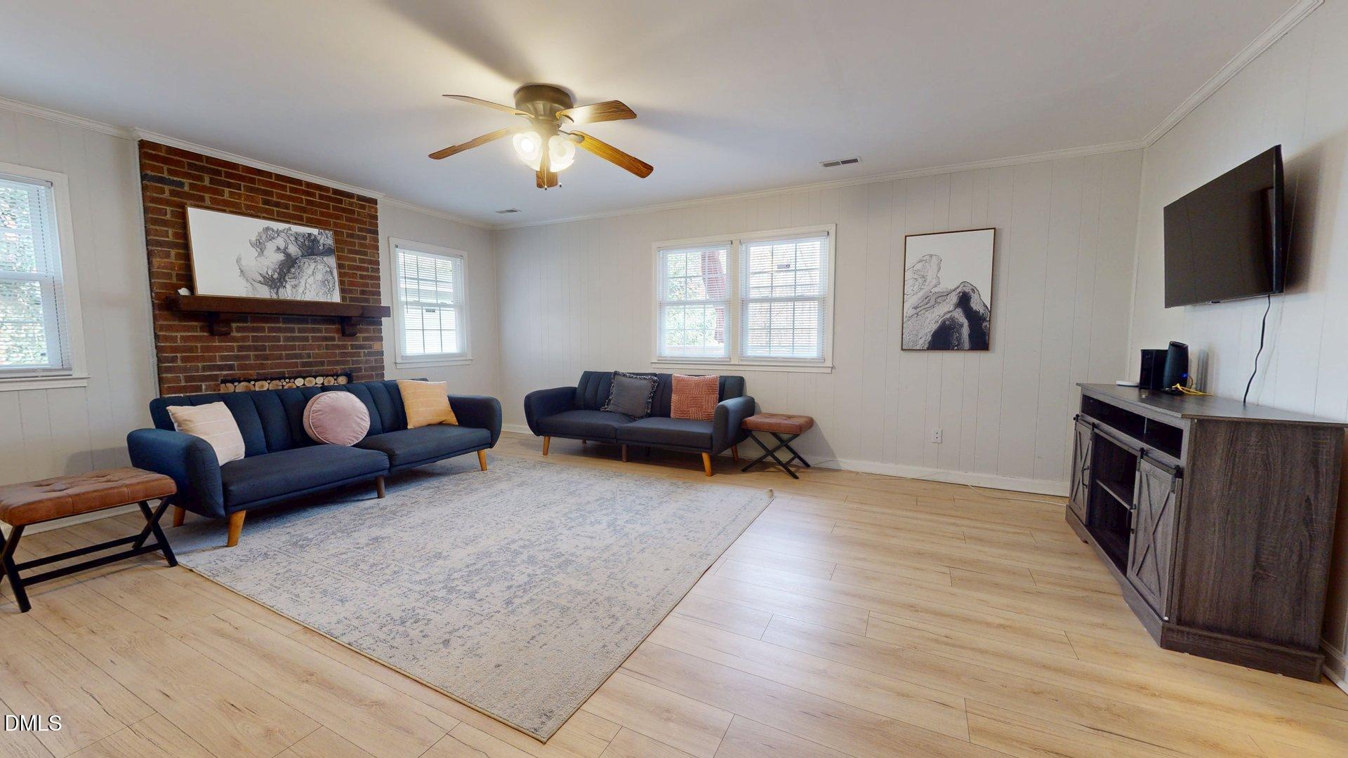 7720 Foxwood Drive Raleigh, NC 27615 - Photo 19 of 46 a living room with furniture and a flat screen tv