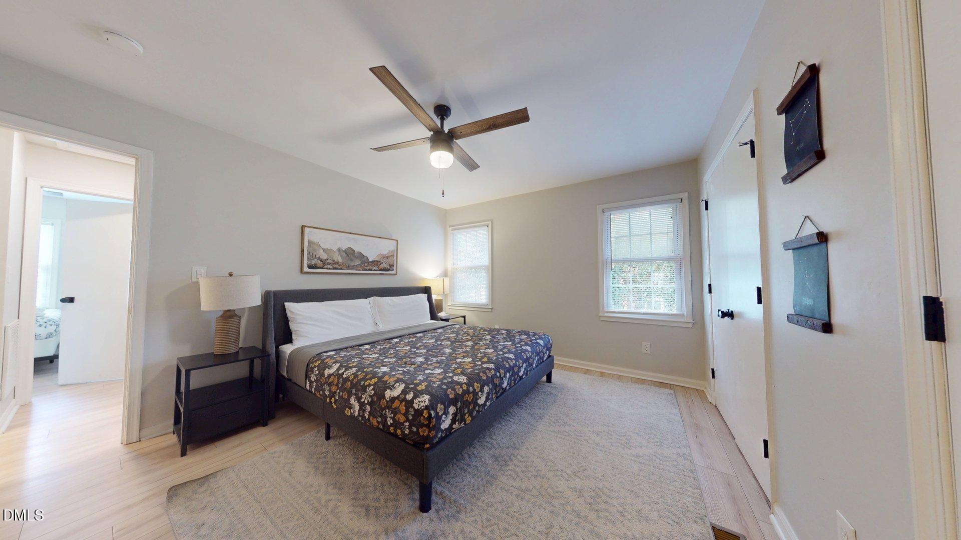 7720 Foxwood Drive Raleigh, NC 27615 - Photo 20 of 46 a bedroom with a bed a couch and a window