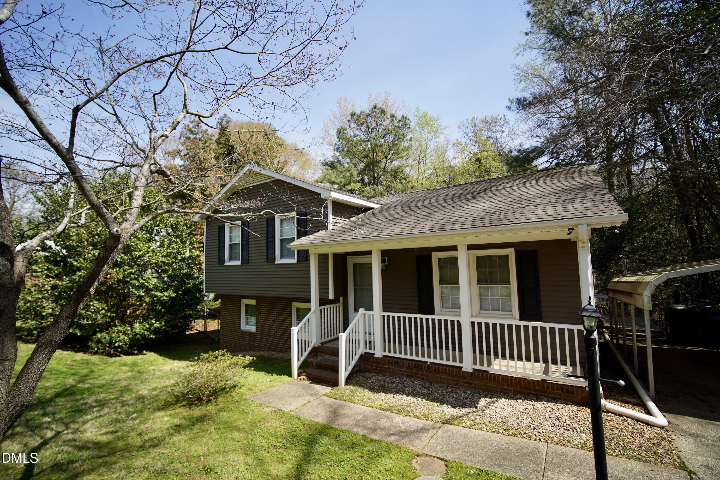 7720 Foxwood Drive Raleigh, NC 27615 - Photo 2 of 46 a view of a brick house with a large window and a yard