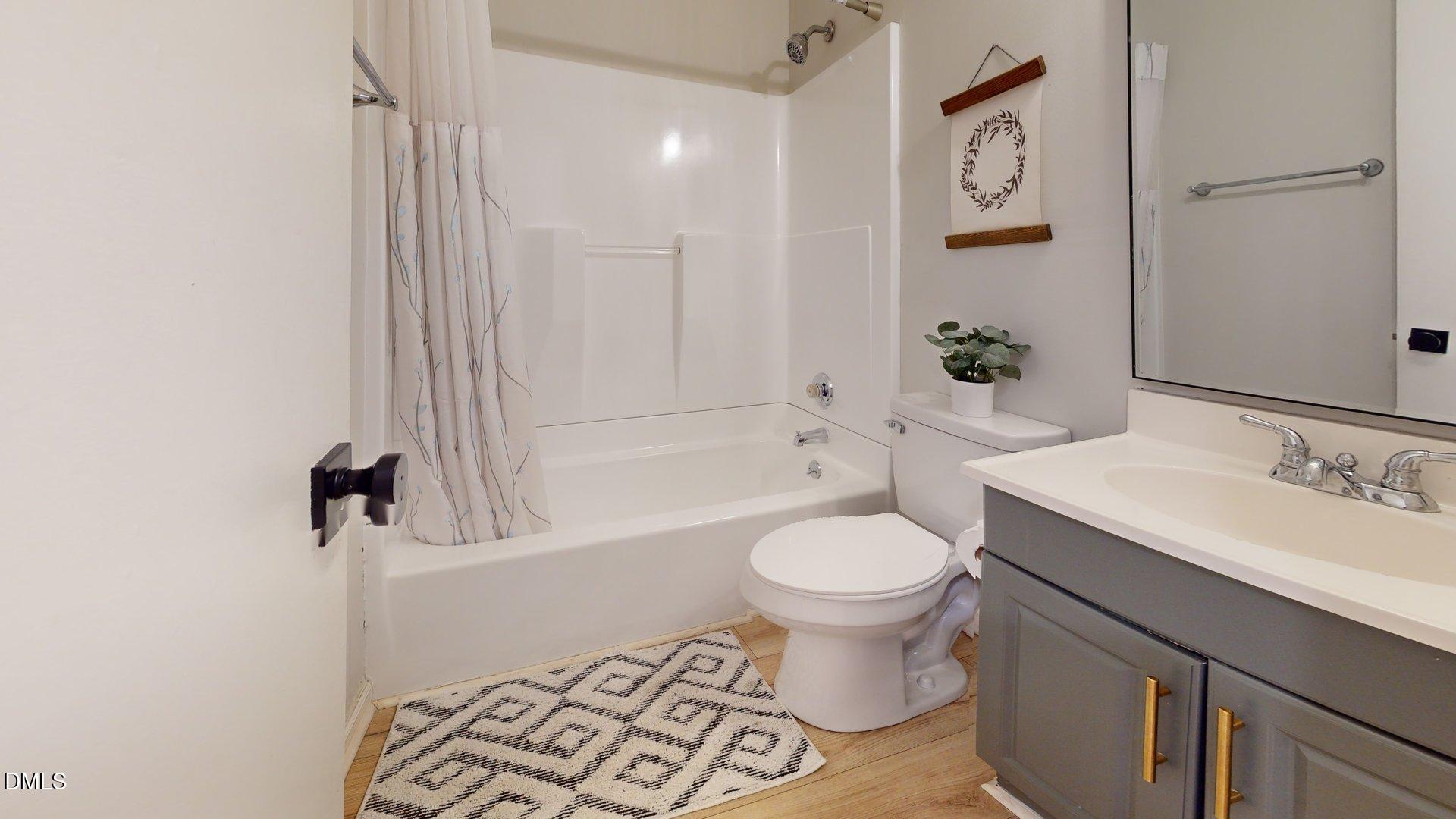 7720 Foxwood Drive Raleigh, NC 27615 - Photo 21 of 46 a bathroom with a sink toilet and shower